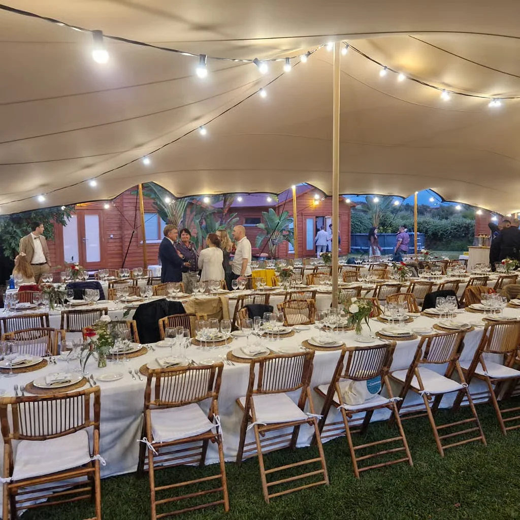 Guests gathered on the lawn with white umbrellas